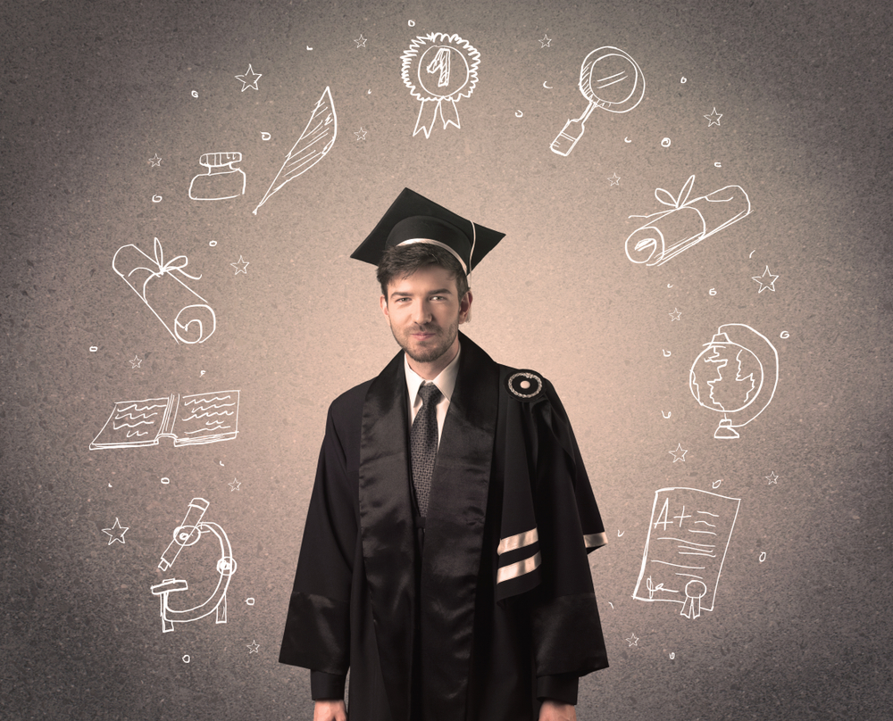 Happy graduate teenager with hand drawn school icons above his head